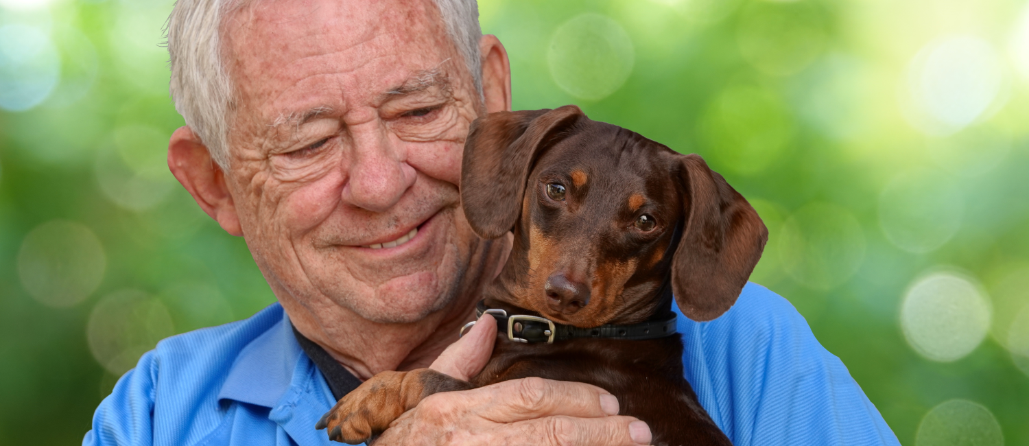 Senior smiling holding a puppy